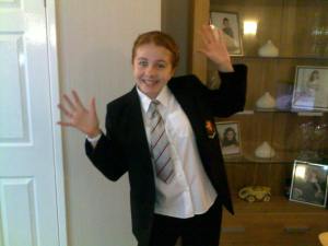A rather flattering picture of me on my first day of school (By the way i do not have a glowing yellow eye...That is just a side affect of my mums fantastic photography!).. .. JAZZ HAANDS!! 